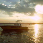 Parasailing boat sunset