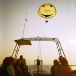 Parasailing boat sunset